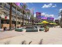 Vibrant outdoor shopping center boasting palm trees, dining options, and entertainment venues for residents at 10281 N 115Th Ave, Youngtown, AZ 85363