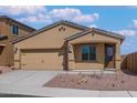 Inviting single-story home featuring a neutral color scheme, well-kept landscaping, and an attached two-car garage at 10281 N 115Th Ave, Youngtown, AZ 85363
