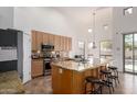 Well-lit kitchen featuring a kitchen island with barstool seating, stainless steel appliances, and granite countertops at 12442 N Via La Playa --, Fountain Hills, AZ 85268