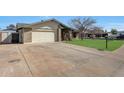 Brick home with a spacious driveway, two-car garage, and lush green lawn at 13633 N 40Th Dr, Phoenix, AZ 85029