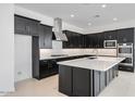 Modern kitchen featuring black cabinets, stainless steel appliances, white subway tile backsplash, and an island at 14194 W Sand Hills Rd, Surprise, AZ 85387