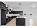 Open kitchen featuring an island, black cabinets, stainless steel appliances, and eat in kitchen at 14194 W Sand Hills Rd, Surprise, AZ 85387