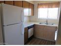 Bright kitchen equipped with white appliances, functional cabinets, and a practical layout at 16528 E Gunsight Dr # 206, Fountain Hills, AZ 85268