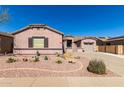Charming single-story home with desert landscaping and a two-car garage at 17574 W Gelding Dr, Surprise, AZ 85388
