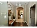 Welcoming entryway with modern light fixture, decorative mirror, and arched doorways at 17594 N 98Th Way, Scottsdale, AZ 85255