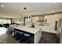 Open-concept kitchen featuring a large island with seating and modern lighting at 17594 N 98Th Way, Scottsdale, AZ 85255