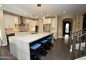 Spacious kitchen with a large island, white cabinets, and stainless steel appliances at 17594 N 98Th Way, Scottsdale, AZ 85255