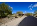 Scenic street view of a home with desert landscaping and mature trees at 17594 N 98Th Way, Scottsdale, AZ 85255