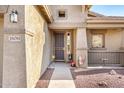Close-up of front entrance with security door and a small seating area at 18081 W Tasha Dr, Surprise, AZ 85388