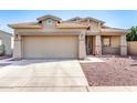 Inviting single-Gathering home featuring desert landscaping, a two-car garage, and a cozy front porch at 18081 W Tasha Dr, Surprise, AZ 85388