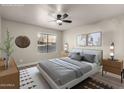 Serene bedroom with a ceiling fan, a large window, and modern decor at 1905 E University Dr # 162, Tempe, AZ 85288