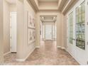 Elegant hallway features high ceilings, tile flooring, and decorative wall art at 20584 W Hillcrest Blvd, Buckeye, AZ 85396