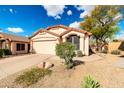 Charming single-story home with a two car garage, desert landscaping and blue skies at 21640 N 48Th St, Phoenix, AZ 85054