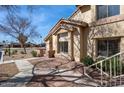 A sunny exterior view of a cozy townhome showing the entrance framed by desert landscaping at 2201 N Comanche Dr # 1080, Chandler, AZ 85224