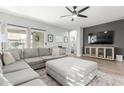 Comfortable living room with large gray sectional, neutral walls, and a view to backyard at 3780 E Waterman St, Gilbert, AZ 85297