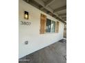 Close-up of exterior showcasing shutters, modern lighting, and house number at 3807 N 64Th Dr, Phoenix, AZ 85033