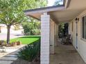 Inviting covered porch with brick pillars, offering a shady retreat at 4145 E Libby St, Phoenix, AZ 85032