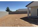 Spacious backyard ready for customization with block wall fence and covered patio at 481 N 17Th St, Coolidge, AZ 85128