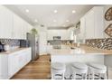 Bright kitchen featuring white cabinets, stainless steel appliances, and a breakfast bar at 4979 E Colonial Dr, Chandler, AZ 85249