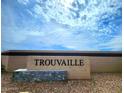 An attractive stone and brick community sign reads 'Trouvaille' under a beautiful blue sky at 5005 S 106Th Ave, Tolleson, AZ 85353