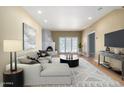 Comfortable living room featuring a modern sofa, stylish decor, and a cozy fireplace at 5200 S Lakeshore Dr # 106, Tempe, AZ 85283
