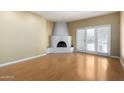 Spacious living room with a striking corner fireplace and bright sliding glass doors at 5200 S Lakeshore Dr # 106, Tempe, AZ 85283