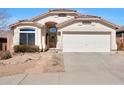 Beautiful single-story home presents a well-kept yard with desert landscaping and a convenient two-car garage at 6408 W Prickly Pear Trl, Phoenix, AZ 85083