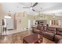 Open-concept living room with wood floors, ceiling fans, and easy access to the kitchen at 6551 E Quartz St, Mesa, AZ 85215