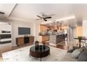 Open-concept living room features a breakfast bar, kitchen, and modern entertainment center at 6803 E Main St # 3306, Scottsdale, AZ 85251
