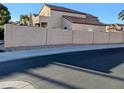 Street view of the side of the house and wall in a suburban neighborhood on a sunny day at 6901 W Marco Polo Rd, Glendale, AZ 85308