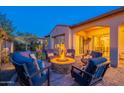 Charming backyard patio featuring a cozy fire pit surrounded by comfortable seating for outdoor relaxation and entertainment at 706 E La Palta St, Queen Creek, AZ 85140