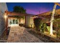 Beautiful courtyard featuring a stone path, lush landscaping, and architectural details at 8845 E Sierra Pinta Dr, Scottsdale, AZ 85255