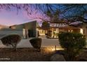 Elegant home exterior featuring desert landscaping, a covered entry and architectural design elements at 8845 E Sierra Pinta Dr, Scottsdale, AZ 85255