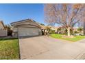 Home with a well-maintained lawn, desert landscaping, and an attached two-car garage at 950 W Cooley Dr, Gilbert, AZ 85233