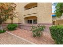 Inviting building exterior showcasing lush landscaping and multiple levels with private balconies at 12221 W Bell Rd # 119, Surprise, AZ 85378