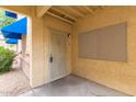 Neutral apartment front door with a security screen, and exterior mail drop at 12221 W Bell Rd # 119, Surprise, AZ 85378