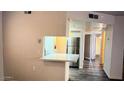 Living Room with hardwood floors and view into the kitchen with stainless steel refrigerator at 12221 W Bell Rd # 119, Surprise, AZ 85378