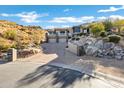 Beautiful view of the home with desert landscaping and long driveway on a circular drive at 14725 N Mariposa Ct, Fountain Hills, AZ 85268