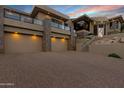 Beautiful home featuring a three-car garage, desert landscaping, and a brick paved driveway at 14725 N Mariposa Ct, Fountain Hills, AZ 85268