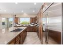 Modern kitchen featuring stainless steel appliances, a center island, and ample counter space at 1474 E Elysian Pass, Queen Creek, AZ 85140