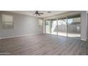 Spacious living room with tile flooring, recessed lighting, and sliding glass door to the backyard at 16227 W Mariposa Grande --, Surprise, AZ 85387