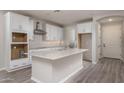 Bright kitchen featuring white cabinets, stainless steel appliances, and a center island with a sink at 16277 W Mariposa Grande --, Surprise, AZ 85387