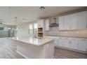 Spacious kitchen with white cabinets, a center island with a sink, and stainless steel appliances at 16277 W Mariposa Grande --, Surprise, AZ 85387