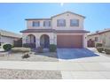 Charming two-story home featuring a tile roof, arched entryway, and well-maintained landscaping at 16763 W Adams St, Goodyear, AZ 85338