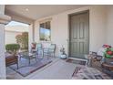 Cozy covered front porch featuring stylish seating and a welcoming entryway at 16763 W Adams St, Goodyear, AZ 85338