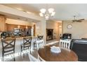 Inviting dining area open to kitchen and living room with a neutral color palette and wood table at 17064 N Willow Path, Surprise, AZ 85374