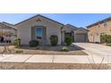 Well-maintained home showcases desert landscaping, a three-car garage, and a charming exterior at 18369 W La Senda Dr, Surprise, AZ 85387