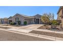 Beautiful home with three-car garage, desert landscaping, and a welcoming facade under a clear blue sky at 18369 W La Senda Dr, Surprise, AZ 85387