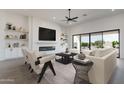 Inviting living room with a modern fireplace, built-in shelves, and a large sliding glass door at 20255 W Highland Ave, Litchfield Park, AZ 85340