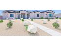 Charming single-story home featuring desert landscaping and a well-defined walkway at 20277 W Highland Ave, Litchfield Park, AZ 85340